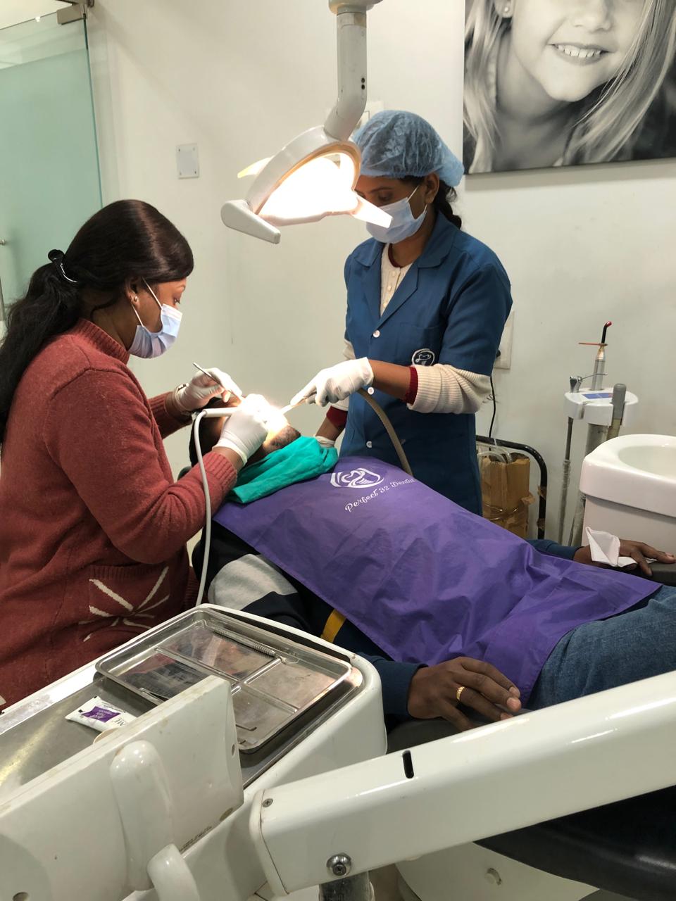 Dentist performing a dental treatment procedure at Perfect 32 Dental Clinic, Ranchi